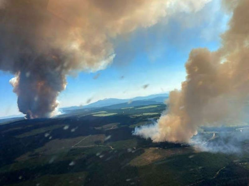 Plumes of smoke rise from the Long Loch wildfire and the Derrickson Lake wildfire in British Columbia on June 30, 2021-1f040a707b0e75f9933643b496ca0ad71625208684.jpg